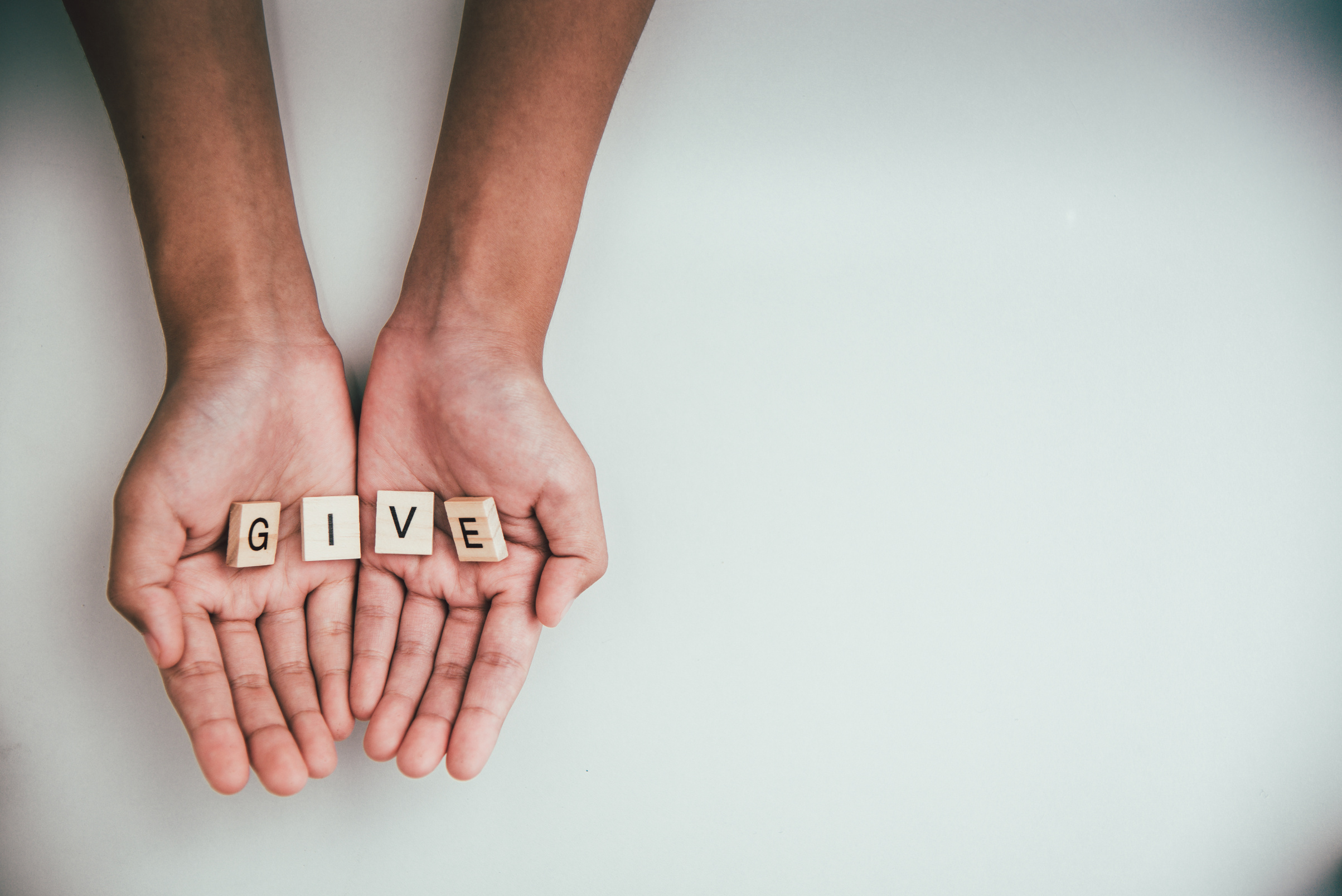 The Word “Give” in a Person’s Hand